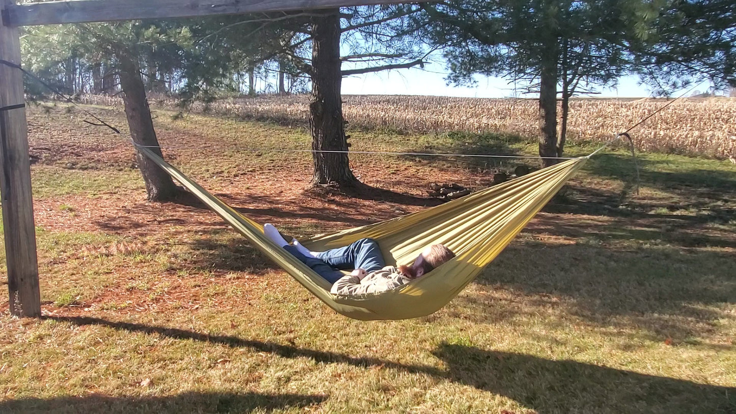 a cool guy named matt smith laying in a olive green netless camping hammock made from olive drab ripstop nylon fabric from ripstop by the roll rbtr