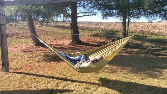 a cool guy named matt smith laying in a olive green netless camping hammock made from olive drab ripstop nylon fabric from ripstop by the roll rbtr